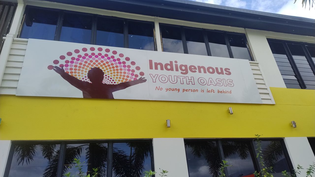 Signage with Indigenous person and characterised rainbow with name of the Indigenous Youth Oasis